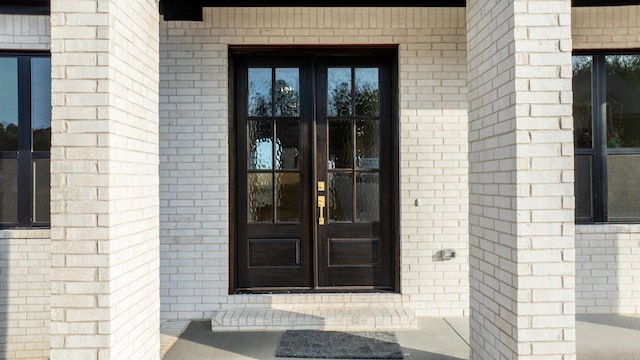 doorway to property with a porch and french doors