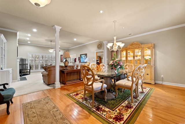 dining area with ceiling fan with notable chandelier, light hardwood / wood-style floors, and crown molding