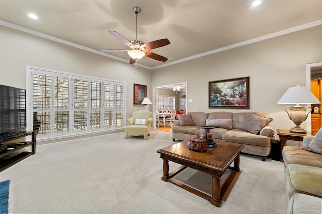 carpeted living room featuring ceiling fan and ornamental molding