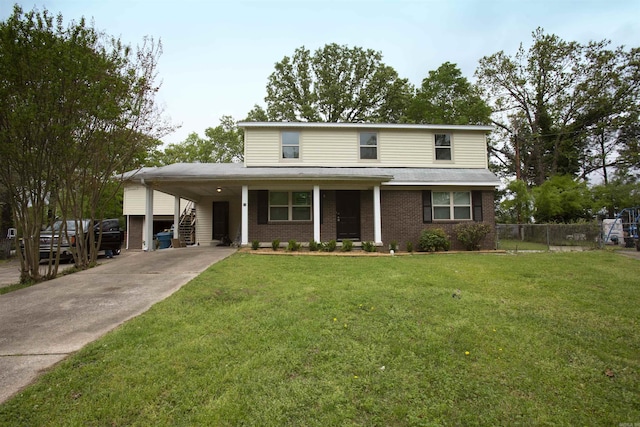 view of front of home with a front yard and a carport