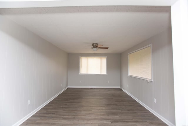 unfurnished room featuring ceiling fan and dark hardwood / wood-style flooring