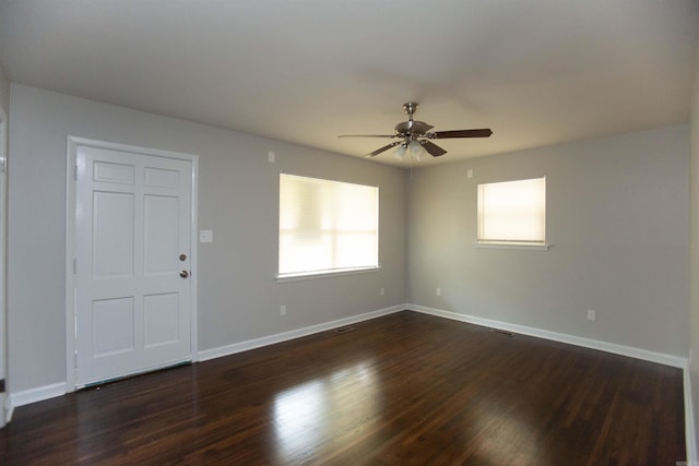 empty room featuring ceiling fan and dark wood-type flooring