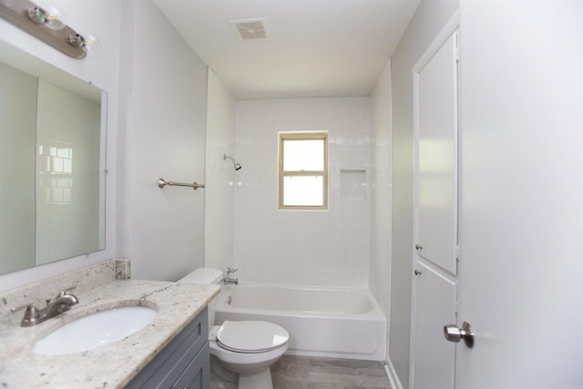 full bathroom featuring hardwood / wood-style flooring, vanity, toilet, and tiled shower / bath