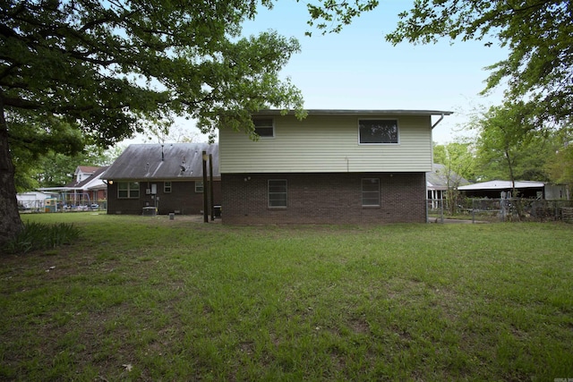 rear view of house with a lawn