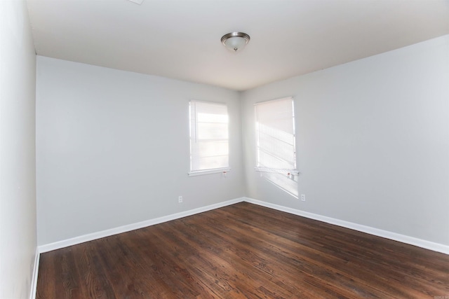 spare room featuring dark wood-type flooring