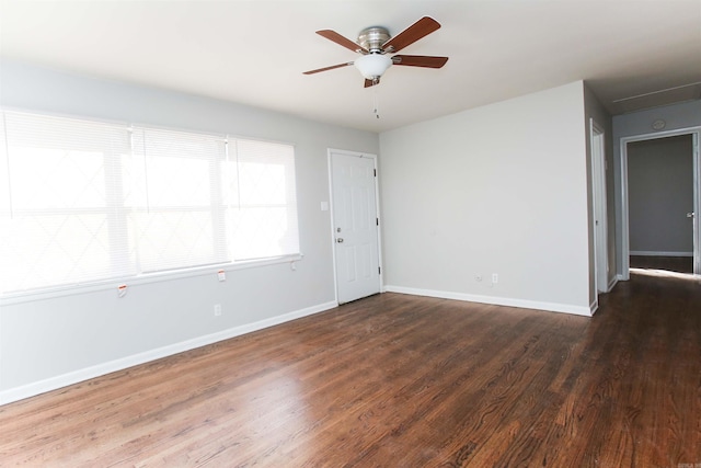 unfurnished room featuring dark hardwood / wood-style floors and ceiling fan