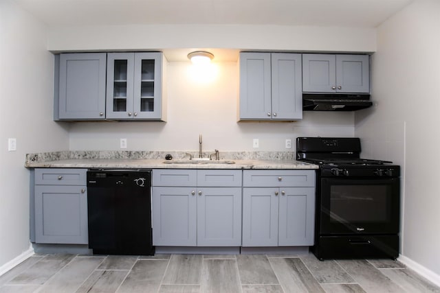 kitchen featuring black appliances, gray cabinets, light wood-type flooring, and sink