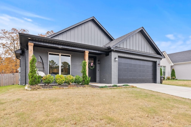 view of front of property with a front yard and a garage