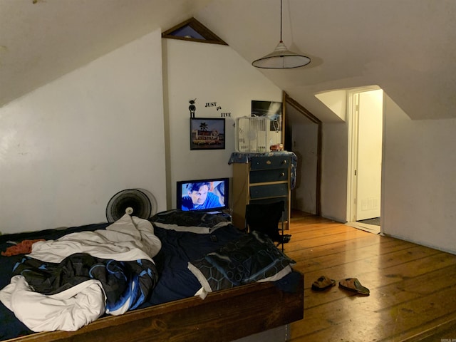 bedroom featuring lofted ceiling and light wood-type flooring