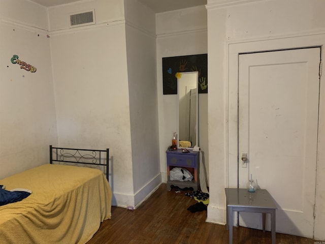 bedroom featuring dark hardwood / wood-style flooring