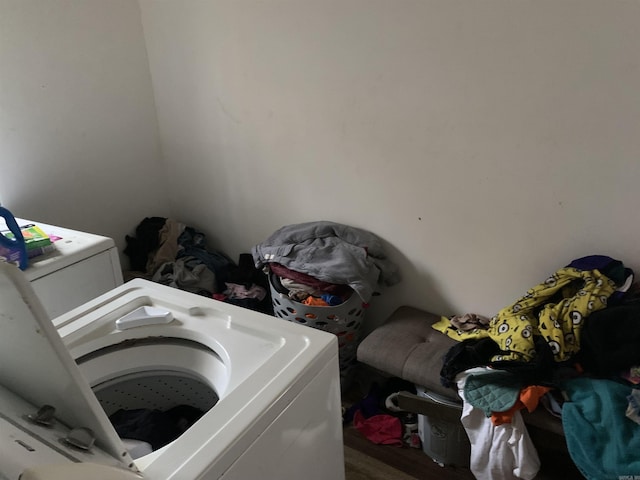 washroom featuring hardwood / wood-style flooring and independent washer and dryer