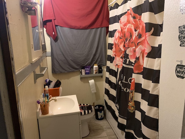 bathroom featuring vanity and shower / bathtub combination with curtain