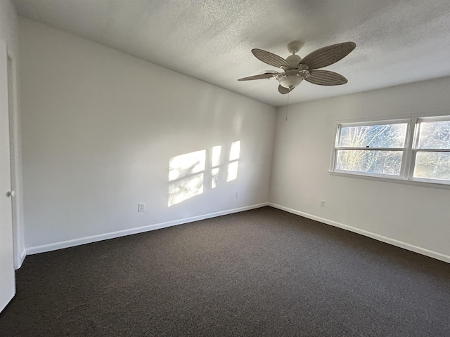 carpeted spare room featuring ceiling fan and a textured ceiling