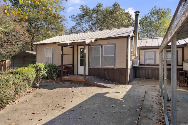 view of front of home with a carport and cooling unit