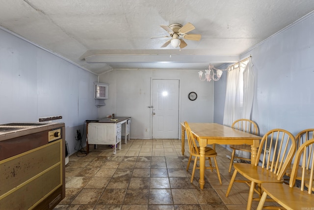 dining space with ceiling fan with notable chandelier, lofted ceiling, and a textured ceiling