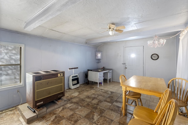 interior space featuring ceiling fan with notable chandelier and heating unit