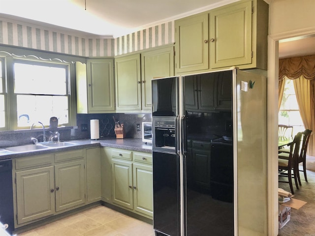 kitchen with light tile patterned flooring, sink, tasteful backsplash, and black appliances