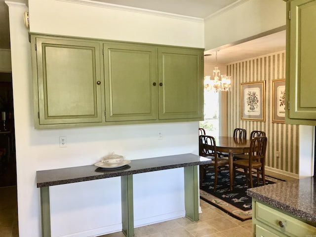 kitchen with ornamental molding, decorative light fixtures, a notable chandelier, green cabinets, and light tile patterned flooring