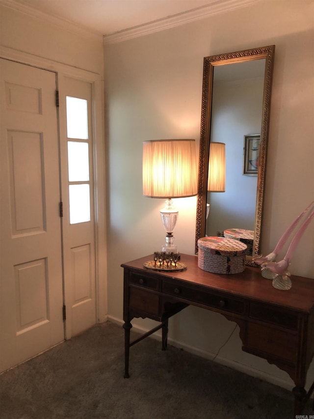 foyer featuring dark carpet and crown molding