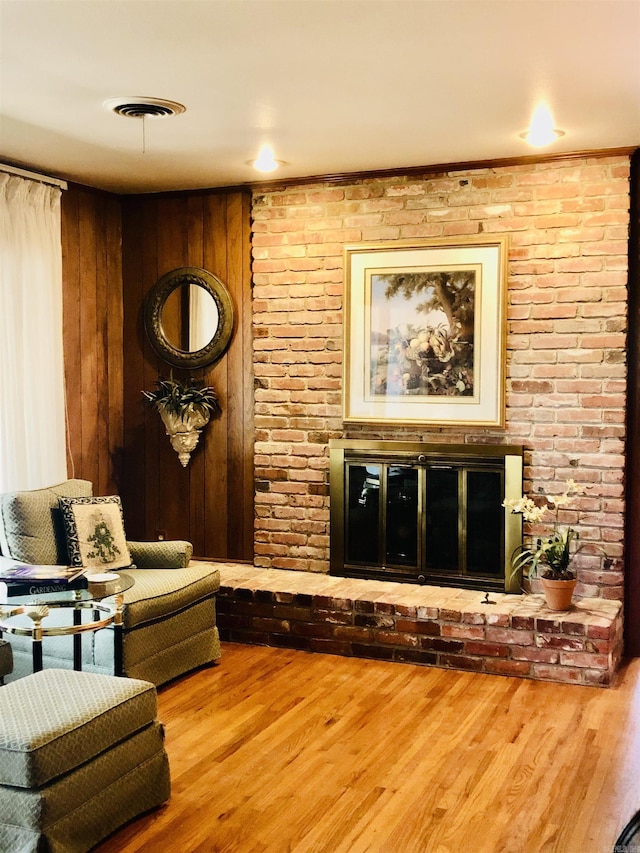 living room with hardwood / wood-style floors and a fireplace