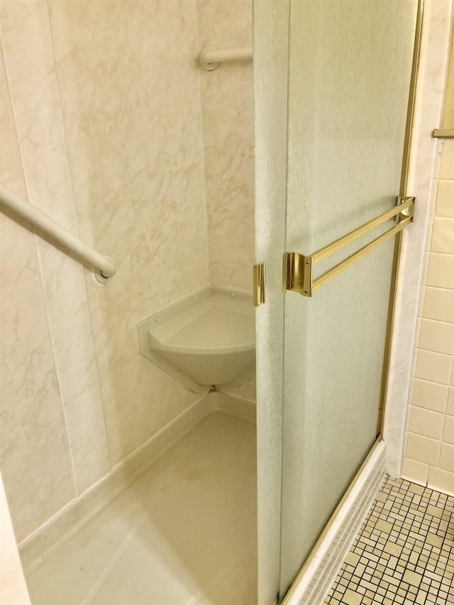 bathroom with tile patterned floors and an enclosed shower