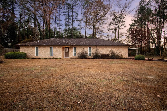 ranch-style home with a yard