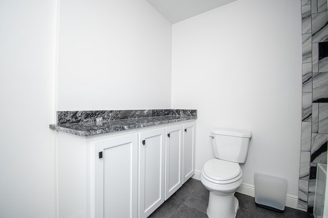 bathroom featuring toilet, vanity, and tile patterned floors