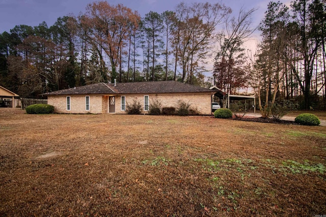 single story home with a carport and a yard