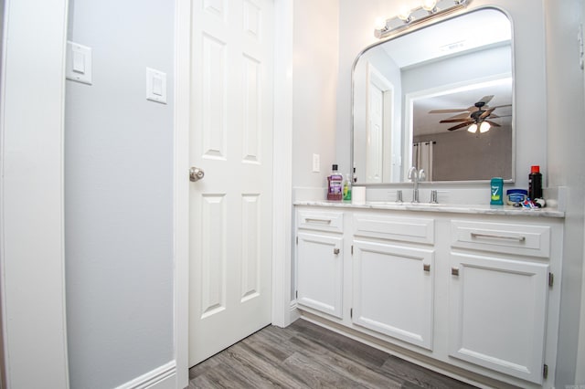 bathroom with vanity, hardwood / wood-style flooring, and ceiling fan