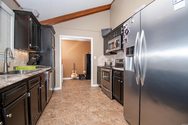 kitchen with decorative backsplash, appliances with stainless steel finishes, ornamental molding, sink, and lofted ceiling with beams