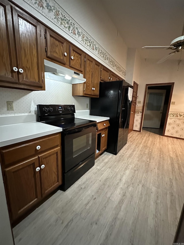 kitchen with black appliances, ceiling fan, and light hardwood / wood-style flooring