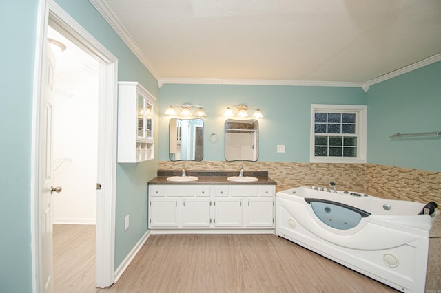 bathroom with a bathing tub, hardwood / wood-style floors, vanity, and crown molding