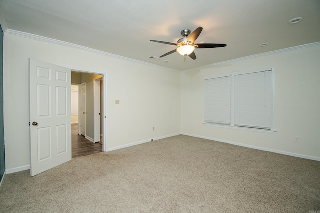 carpeted empty room featuring ceiling fan and ornamental molding