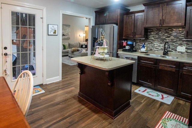 kitchen featuring sink, dark brown cabinetry, stainless steel appliances, and a kitchen island