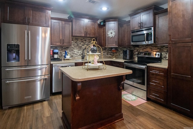 kitchen featuring dark brown cabinets, dark hardwood / wood-style floors, stainless steel appliances, and a kitchen island