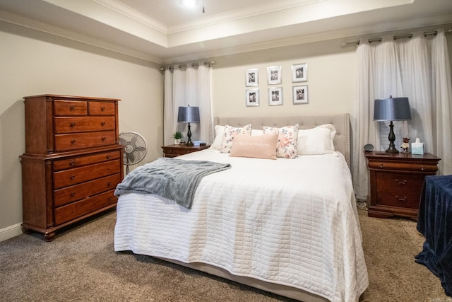 bedroom with carpet, crown molding, and a tray ceiling