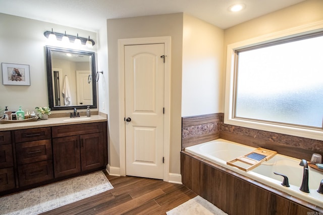 bathroom featuring vanity and a bath