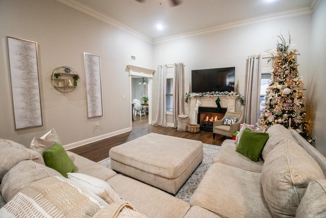 living room with ceiling fan, dark hardwood / wood-style floors, and crown molding