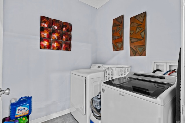 laundry room with light tile patterned floors and washer and dryer