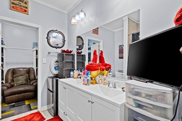 bathroom with vanity and ornamental molding