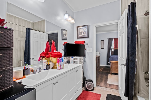 bathroom with vanity, wood-type flooring, and ornamental molding