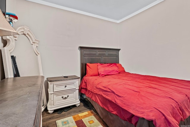 bedroom with dark hardwood / wood-style flooring and ornamental molding