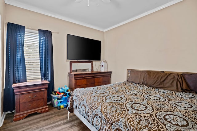 bedroom featuring hardwood / wood-style flooring, ceiling fan, and crown molding