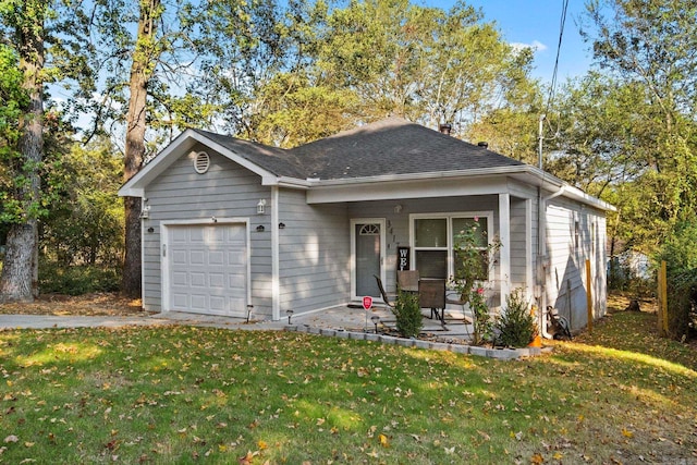 view of front of home featuring a porch, a front yard, and a garage