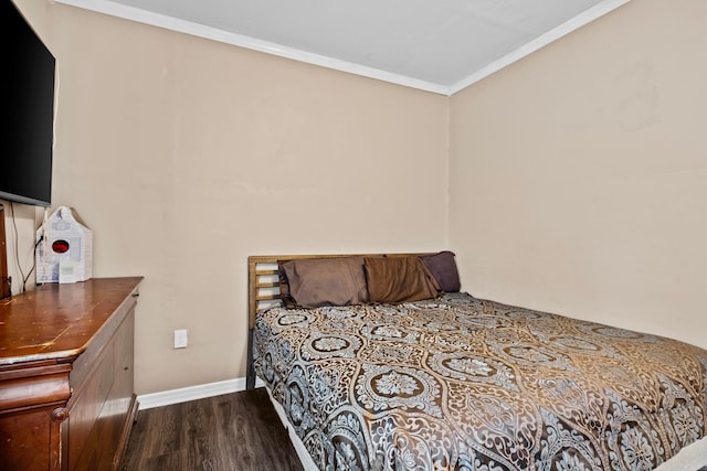 bedroom with hardwood / wood-style floors and ornamental molding