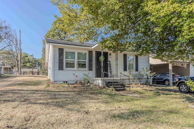 view of front of house with a carport and a front lawn