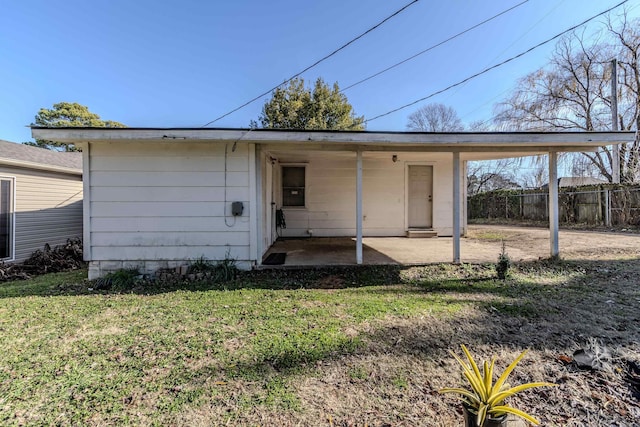 back of house featuring a yard and a patio