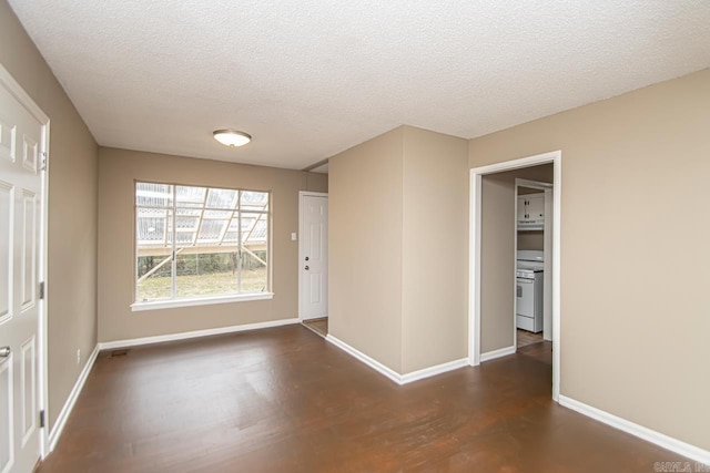 unfurnished room featuring dark hardwood / wood-style flooring and a textured ceiling