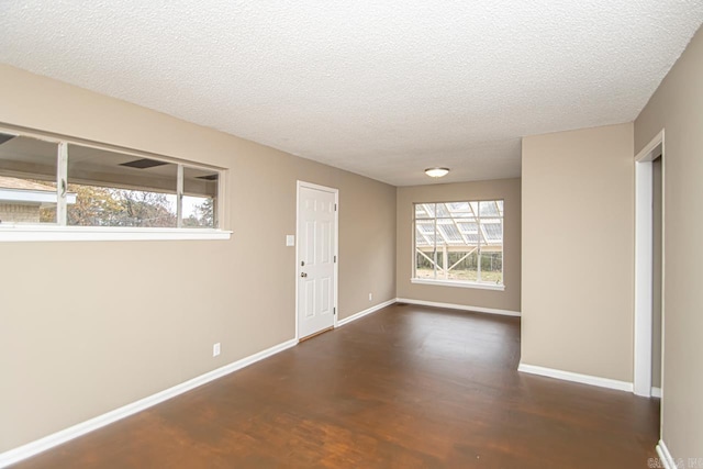 entrance foyer with dark wood-type flooring and a textured ceiling