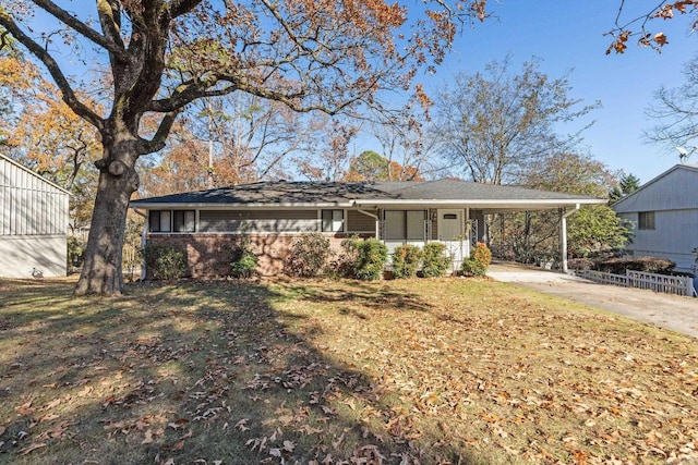 single story home featuring a front yard and a carport